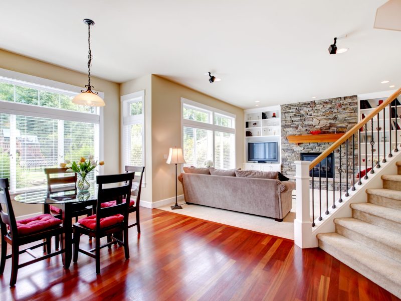 Large living and dining room with staircase, cherry hardwood.